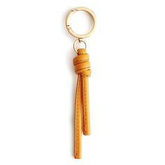 a keychain with a leather tassel hanging from it's center loop