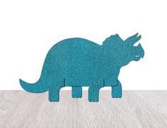 a paper cut out of a dinosaur on a table