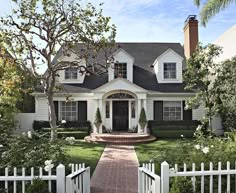 a white house with black shutters on the front