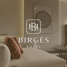 a hotel room with a bed, table and chairs in front of the logo for birges hotel