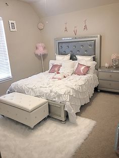 a bedroom with a bed, dresser and chest of drawers in the middle of it