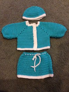 a crocheted blue and white outfit for a baby