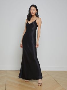 An effortlessly elegant maxi slip dress. A clean v-neckline hangs from adjustable spaghetti straps. Black charmeuse silk skims over curves, creating a slinky silhouette. 100% silk. Black Long Silk Dress, Black Silk Dress Long, Long Black Slip Dress, Long Black Silk Dress, Silk Black Dress, Fancy Gowns, Black Silk Dress, Silk Dress Long, Black Slip Dress