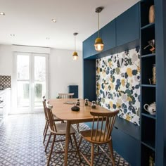 a dining room table with four chairs in front of it