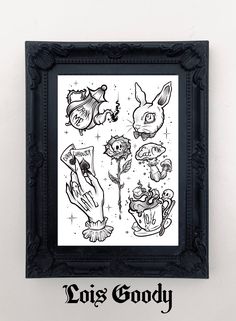 a black frame hanging on the wall next to a white wall with some drawings in it