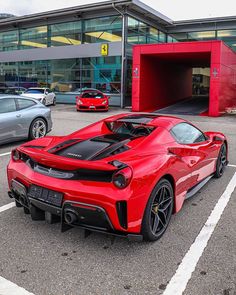 a red sports car parked in a parking lot