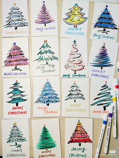 christmas cards with different designs on them next to crayon markers and pencils