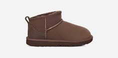 The Classic Ultra Mini features a low shaft height, adding easy on-off and enhanced versatility. Pre-treated to keep it looking better for longer, this Classic features everything kids love about the original: signature sheepskin lining, an ultra-soft UGG®plush insole, and a flexible, ultra-lightweight sole made for all-day play. Pair with our matching adult-sized boot for cute mini-me photo ops.The outsole of this product is either a sugarcane EVA outsole, which is a responsible compound using Ugg Mini Boot, Ultra Mini Ugg, Wishlist Clothes, Ugg Mini Boots, Shoes Wishlist, Ugg Ultra Mini, Ugg Classic Ultra Mini, Ugg Mini, Kids Uggs