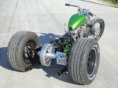 a green and black motorcycle is parked on the street