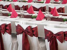 rows of white and red banquet tables with napkins