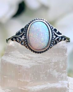 Sterling Silver Oval White Lab Opal Ring | The Life Divine Sterling Silver Oval White Lab Opal RingCherished for its brilliance, Opal is known as a stone of creativity and vitality. Opal is also a reflective stone of protection, absorbing energies and sending them back to their source.Measures approximately 3/8" H x 1/2" W Oval Opal Rings With Spiritual Style, Spiritual Oval Opal Promise Ring, Spiritual Oval Opal Birthstone Ring, Spiritual Oval Opal Ring, Bohemian Opal Oval Ring, Spiritual Oval Opal Jewelry, White Oval Spiritual Jewelry, Adjustable Oval Spiritual Rings, Oval Sterling Silver Opal Ring Spiritual Style