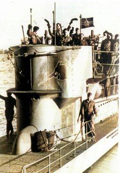 a group of men standing on top of a boat