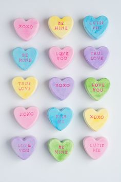 six conversation hearts with the words be mine and true love written on them in different colors