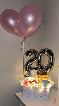 a table topped with balloons and gifts for someone's 30th birthday