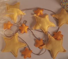 some yellow and brown stars are hanging from string