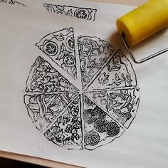 a pizza sitting on top of a piece of paper next to a yellow rubber stamp