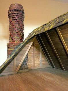 an attic with a brick chimney and wooden floor