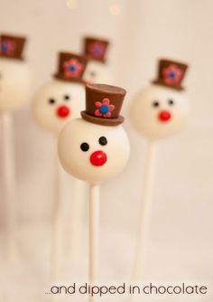 cake pops with frosting and chocolate on them are decorated like snowmen wearing top hats