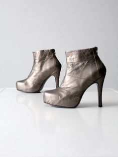 This is a pair of vintage metallic silver leather platform boots. Daring high heels catapult these ankle boots into high style.  CONDITION In good condition with wear consistent with age and use.  Some wear to the outsoles.  APPROXIMATE FIT:  8.5 / 39 MEASUREMENTS Insole Length:  10"  .. 25.4 cm Outsole Width:  3.125"  .. 7.9 cm Platform Height:  1"  .. 2.54 cm Heel:  4.75"  .. 12.1 cm 121848 Silver Ankle Boots, Leather Platform Boots, Hippie Boots, Silver Platforms, Platform Ankle Boots, Fashion Sale, Platform Boots, Boot Shop, Fashion Details