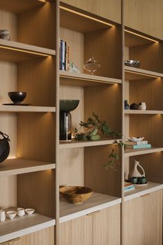 the shelves are lined with vases and bowls