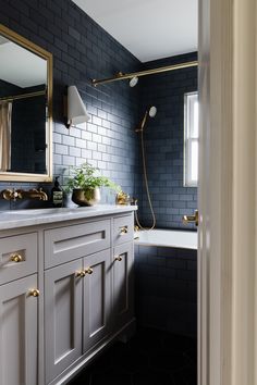 a black and white bathroom with gold accents