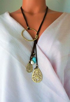 Lovely Leather Lariat necklace. Genuine Turquoises tassel, Unique design NEW vacation Jewelry purchase, never used This is a stunning statement necklace Components include: shiny gold tone quality Brass Genuine 31 inch flat Leather 6 inch Leather Tassel with stone and Brass dangles Handmade in Asia Ready to ship NO waiting Only ONE necklace available Thank you so much for visiting :kaysclassyboutique@etsy.com Elegant Adjustable Turquoise Lariat Necklace, Elegant Adjustable Lariat Turquoise Necklace, Adjustable Dangle Tassel Necklace For Festivals, Bohemian Lariat Necklace With Adjustable Chain As Gift, Adjustable Elegant Tassel Necklace For Festival, Bohemian Long Tassel Necklace With Adjustable Chain, Turquoise Bohemian Tassel Necklace, Adjustable Lariat Turquoise Necklace, Adjustable Turquoise Necklace For Festivals