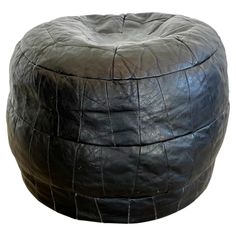 Sophisticated black leather pouf/ottoman by Swiss designer De Sede with triangular patchwork and a final octagonal leather patch at the top. This pouf is in a slightly larger size. Handmade with wonderful faded patina. Gorgeous accent piece. Good vintage condition. Wear appropriate with age. Brand new filler. Perfect living room decor, foot rest or extra seating. 2 available. Images 2-10 are ottoman #1 and images 11-18 are ottoman #2. Priced individually. Black Ottoman Pouf, 1930s Interior Design, Leather Pouf Ottoman Black, Lether Ottoman, Perfect Living Room Decor, Round Leather Ottoman Pink Vintage, Leather Pouf Ottoman, Leather Patchwork, Leather Pouf