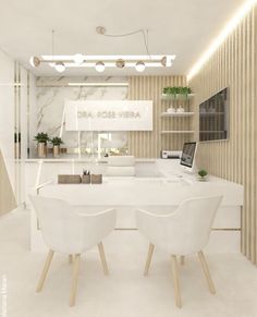 a white table and chairs in a room with lights on the ceiling above it is a laptop computer