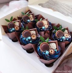 a box filled with cupcakes sitting on top of a table