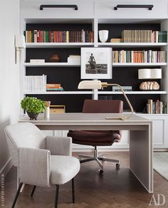 an office with a desk, chair and bookshelf in the back ground area