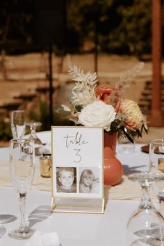 the table is set up with wine glasses and place cards for guests to take pictures