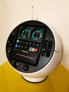 an electronic device sitting on top of a yellow table