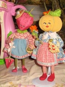 two dolls are standing next to each other