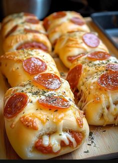 several slices of pepperoni pizza on a cutting board