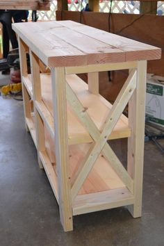 a table made out of wooden planks in a garage with tools and supplies nearby