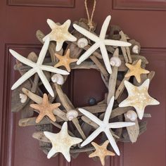 a wreath made out of driftwood with starfishs and seashells on it