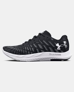 the under armour black and white running shoe is on display in front of a gray background