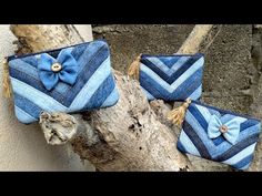 three blue purses sitting on top of a tree branch