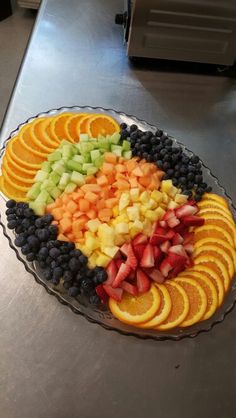 a platter filled with sliced fruit on top of a counter