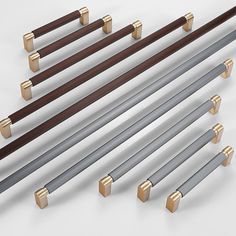 six different types of handles and bars on a white surface with gold trimmings