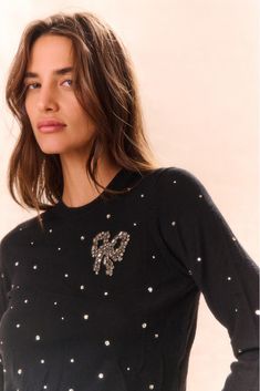 Easy and cozy the Pammie Pullover arrives. Designed from 100% merino wool, this warm, lightweight pullover debuts with a slim fit and a hand-sewn LoveShackFancy bow reimagined with crystals placed at the chest. Tiny crystal details are sprinkled all over the sweater while a high rib detail is featured at the back. Chic Wool Sweater With Pointelle Knit, Luxury Cozy Pointelle Knit Sweater, Luxury Fitted Pointelle Knit Sweater, Luxury Wool Pointelle Knit Sweater, Loveshackfancy Bow, Luxury Embellished Fitted Sweater, Bow Sweater, Wool Pullover, Pink Frosting