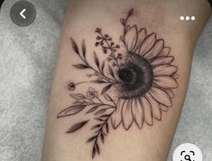 a black and white photo of a sunflower tattoo