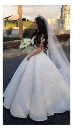 a woman wearing a wedding dress and veil