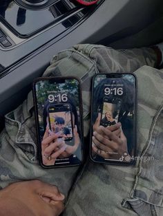 two people are holding their cell phones while sitting in the car