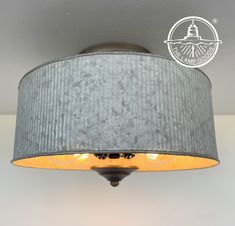 the light fixture is made from an old tin can and has a gray shade on it