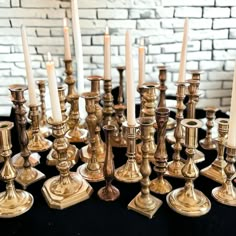 a table topped with lots of gold candles