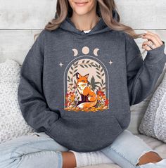 Cute Floral Fox Hoodie, Vintage Floral Cottagecore Hoodie, Wildflower Meadow, Forestcore Hoodie, Goblincore Fox Hoodie, Spy Fox,Hiking Gift   PRODUCT DETAILS 💫Youth Hoodies do not have drawcord for added safety💫 - Our hoodies are made for comfort with a 50% cotton and 50% polyester blend. - They're built to last with a medium-heavy fabric  (8.0 oz/yd² (271 g/m - Enjoy a relaxed fit and a sewn-in label. - Get the right size with our true-to-size guide.   SIZING - Find your perfect fit in our si Cottagecore Hoodie, Fox Hoodie, Wildflower Meadow, Animal Hoodie, Floral Cottagecore, Floral Hoodie, Hiking Gifts, Cute Flower, Youth Hoodies