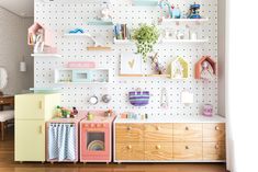 there are many toys on the shelves in this playroom with pegboards and shelving