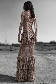 The Nomad Dune Layered Maxi Dress combines an earthy, distressed look with luxurious ruffled layers. Its floor-length silhouette, loose fit, and lace-up front detail evoke a rugged, post-apocalyptic vibe. This dress makes a bold, rebellious statement perfect for daring, avant-garde fashionistas. Features: Material: Cotton, Polyester blend Fit: Slim, flowy silhouette Style: Distressed, Layered, Floor-length Decoration: Ruffled tiers Occasion: Glamorous/Posh, Statement piece Season: Summer/Autumn Layered Maxi Dress, Post Apocalyptic, Dress Pant, New Instagram, Season Summer, All Seasons, Dress Making, Floor Length, Ruffles