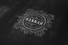 a black and white logo with the word hannah on it's center circle, surrounded by ornate swirls